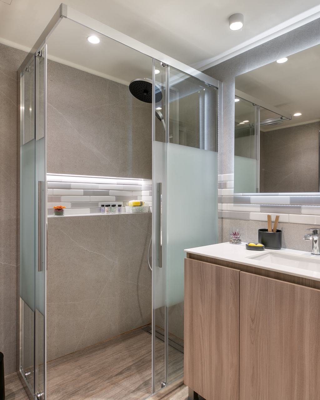 Bathroom with a glass walk-in shower and oak vanity